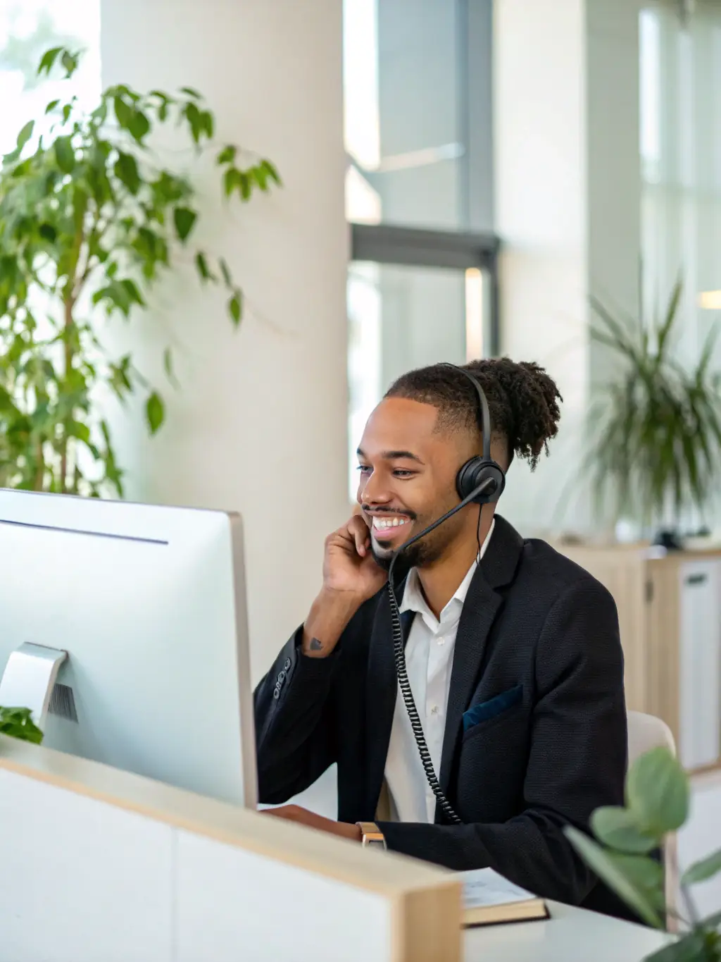 A friendly customer service representative assisting a client via video call, both smiling and engaged in a productive discussion about website features.